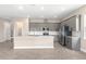Modern kitchen featuring gray cabinets, stainless steel appliances, and a large center island at 1262 Champions Dr, Daytona Beach, FL 32124
