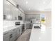 Modern kitchen featuring stainless steel appliances, gray cabinets, and an island at 1262 Champions Dr, Daytona Beach, FL 32124