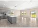 Modern kitchen featuring gray cabinets, a stainless steel refrigerator, and a large island at 1262 Champions Dr, Daytona Beach, FL 32124