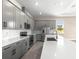Well-equipped kitchen features gray cabinets, stainless steel appliances, and sleek countertops at 1262 Champions Dr, Daytona Beach, FL 32124