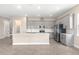An island kitchen featuring gray cabinets and stainless steel appliances at 1262 Champions Dr, Daytona Beach, FL 32124