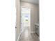 Hallway leading to laundry room featuring modern gray cabinetry and an adjacent utility room at 1262 Champions Dr, Daytona Beach, FL 32124