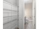 Walk-in pantry with wire shelving, adjoining half-bathroom featuring modern vanity and toilet at 1262 Champions Dr, Daytona Beach, FL 32124