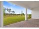 Patio with views of the green lawn and trees at 1262 Champions Dr, Daytona Beach, FL 32124