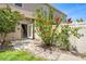 Enchanting backyard with hibiscus bush, lawn, stone pathway, and a white privacy fence at 12963 Garridan Ave, Windermere, FL 34786