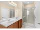 Bathroom features a double sink vanity, shower, and ample cabinet space at 12963 Garridan Ave, Windermere, FL 34786