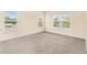 Bright bedroom featuring plush carpet, neutral walls, and multiple windows at 12963 Garridan Ave, Windermere, FL 34786