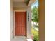 Close-up of the townhome's front entrance, featuring a painted door with sidelight, a front porch and house number at 12963 Garridan Ave, Windermere, FL 34786