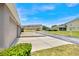 Exterior view of townhome garages, front lawn area, and common driveway in community at 12963 Garridan Ave, Windermere, FL 34786