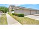 Exterior view of a two-story home featuring a well-maintained lawn and attached garage at 12963 Garridan Ave, Windermere, FL 34786