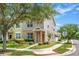 View of the exterior showing a townhome with manicured lawn and sidewalk on a beautiful sunny day at 12963 Garridan Ave, Windermere, FL 34786