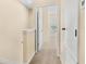 Upstairs hallway with carpet, linen closet, and doorway into bedroom at 12963 Garridan Ave, Windermere, FL 34786