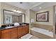 Spacious bathroom featuring double sinks with granite countertops and a separate tub and shower at 1354 Centre Court Ridge Dr # 104, Reunion, FL 34747