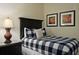 Comfortable bedroom with one bed with black headboard and black nightstand at 1354 Centre Court Ridge Dr # 104, Reunion, FL 34747