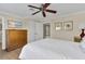 Cozy bedroom with ceiling fan, warm decor, and wood-look flooring at 1354 Centre Court Ridge Dr # 104, Reunion, FL 34747