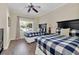 Bedroom with two beds with matching blue and white bedding and a ceiling fan at 1354 Centre Court Ridge Dr # 104, Reunion, FL 34747