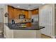 This kitchen features stainless appliances, breakfast bar, wood cabinetry, and tile floors at 1354 Centre Court Ridge Dr # 104, Reunion, FL 34747