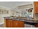 Open kitchen with stainless steel appliances, dark countertops, and light wood cabinetry at 1354 Centre Court Ridge Dr # 104, Reunion, FL 34747