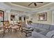 Open concept living room with dining area, featuring a modern chandelier and comfortable seating at 1354 Centre Court Ridge Dr # 104, Reunion, FL 34747