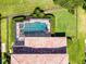 Aerial view of a backyard oasis with a screened-in pool and lush landscaping at 1417 Terralago Pl, Oviedo, FL 32765
