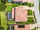 Overhead view of a home with a red tile roof, pool, and manicured lawn at 1417 Terralago Pl, Oviedo, FL 32765