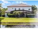 Rear exterior of the home featuring a screened-in pool, pond, and landscaped yard at 1417 Terralago Pl, Oviedo, FL 32765