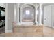 A luxurious bathroom featuring a soaking tub, tiled flooring, and decorative columns at 1417 Terralago Pl, Oviedo, FL 32765