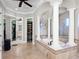 Bathroom featuring a soaking tub with columns and mosaic tile at 1417 Terralago Pl, Oviedo, FL 32765