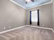 A minimalist bedroom with neutral walls, carpet, and bright windows at 1417 Terralago Pl, Oviedo, FL 32765