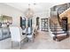 Elegant dining room featuring a staircase with iron railings, a modern chandelier, and tile flooring at 1417 Terralago Pl, Oviedo, FL 32765