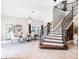 Elegant dining room featuring a staircase with iron railings, a modern chandelier, and tile flooring at 1417 Terralago Pl, Oviedo, FL 32765