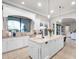 Bright kitchen with white cabinetry, granite countertops, island with seating, and stainless appliances at 1417 Terralago Pl, Oviedo, FL 32765