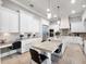 Well-lit kitchen boasting white cabinetry, granite countertops, island with seating, and stainless appliances at 1417 Terralago Pl, Oviedo, FL 32765