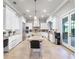 Bright kitchen featuring white cabinets, granite countertops, stainless steel appliances, and a center island at 1417 Terralago Pl, Oviedo, FL 32765