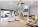 Spacious living room with fireplace, sliding glass doors to the patio, and neutral decor at 1417 Terralago Pl, Oviedo, FL 32765
