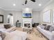 Inviting living room with a fireplace, neutral colors, and comfortable sofas and decorative rug at 1417 Terralago Pl, Oviedo, FL 32765