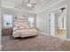 Serene main bedroom with a tray ceiling, plush carpet, and views of the bathroom entry at 1417 Terralago Pl, Oviedo, FL 32765
