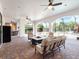 Spacious screened patio with fire pit, ceiling fans, and plenty of seating at 1417 Terralago Pl, Oviedo, FL 32765