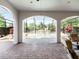 View from the covered brick-paved patio looking out toward the screened pool at 1417 Terralago Pl, Oviedo, FL 32765