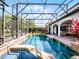 Beautiful screened-in pool and spa area with brick decking and lush landscaping at 1417 Terralago Pl, Oviedo, FL 32765