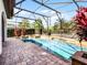 Covered pool area showing travertine pavers and a clear view of the sparkling pool at 1417 Terralago Pl, Oviedo, FL 32765