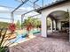 Screened-in pool featuring brick pavers, arched entryway and outdoor lounging area at 1417 Terralago Pl, Oviedo, FL 32765