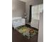 Charming Bedroom featuring a white crib, a dresser, and a jungle-themed rug, creating a playful environment at 1445 Valley Pine Cir, Apopka, FL 32712