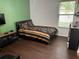 Comfortable bedroom with laminate flooring, a cozy bed, and natural light at 1445 Valley Pine Cir, Apopka, FL 32712