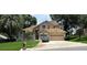 Charming two-story home with a well-manicured lawn, lush landscaping, and a spacious three-car garage at 1445 Valley Pine Cir, Apopka, FL 32712