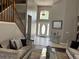 Bright foyer with high ceilings, a decorative mirror, and a staircase with wooden banisters at 1445 Valley Pine Cir, Apopka, FL 32712