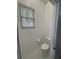 Simple and clean toilet room with tiled flooring and natural light from a window at 1445 Valley Pine Cir, Apopka, FL 32712