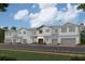 Attractive townhome highlighting white siding, stone accents, dark shutters, and a manicured lawn at 14942 Harvest St, Orlando, FL 32824