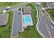 Community pool and clubhouse feature lounge chairs, a pool, and parking at 1580 Delphi Way, New Smyrna Beach, FL 32168