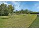 Expansive backyard with mature trees and a tranquil ambiance for outdoor enjoyment at 1580 Delphi Way, New Smyrna Beach, FL 32168